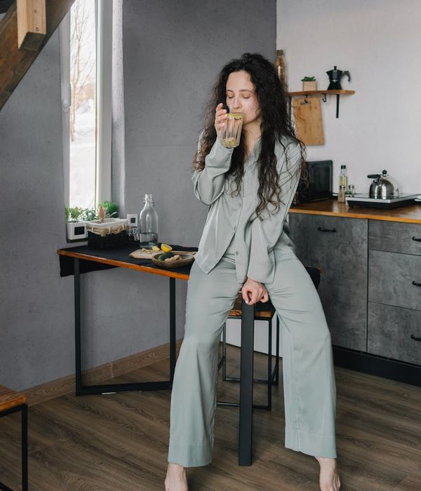 Woman feeling energized and happy during a morning workout at home.